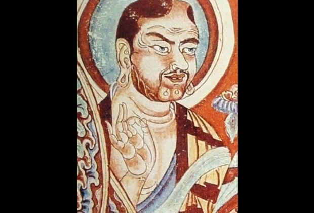 simbolo-do-ok-3_xl Pintura antiga retratando uma figura masculina com halo, gesto de bênção, ao lado de flores e ornamentos coloridos.